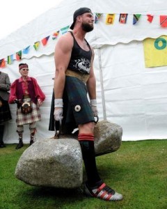 James Gardner lifting the Dinnie Stones unassisted in front of the watcher of the Stones, David Webster.