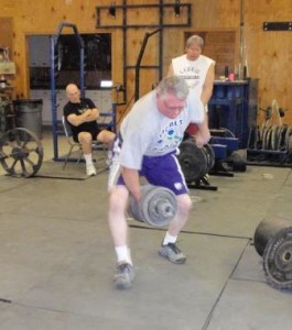 LaVerne competing in the dumbbell walk at a previous Grip Championships.